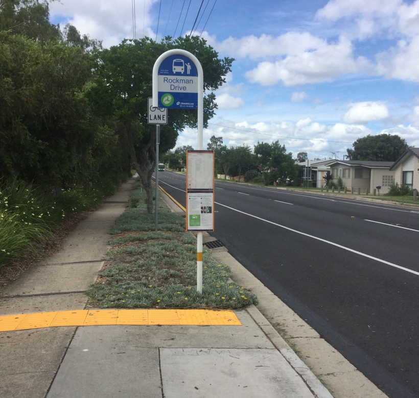 Raceview Street at Rockman Drive Bus Stop Sign with Westside 39 approaching in the background on a route 503 to Riverlink.